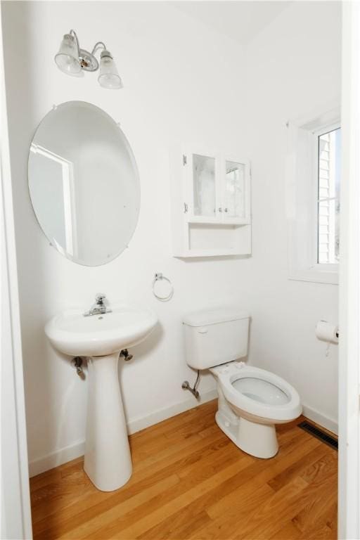 bathroom with wood-type flooring and toilet