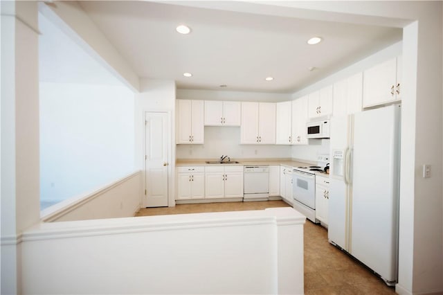 kitchen featuring white cabinetry, sink, and white appliances