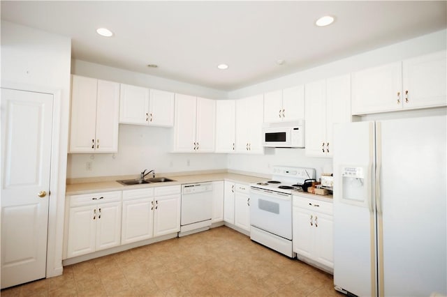 kitchen featuring white cabinetry, white appliances, and sink