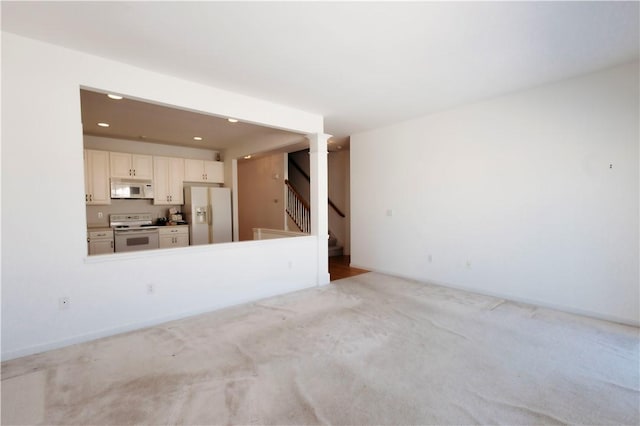 unfurnished living room with light carpet