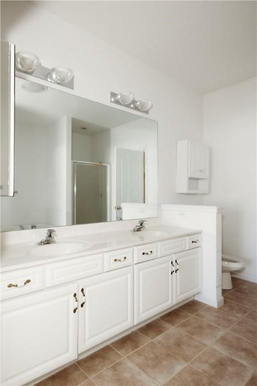 bathroom with vanity, a shower with shower door, tile patterned floors, and toilet