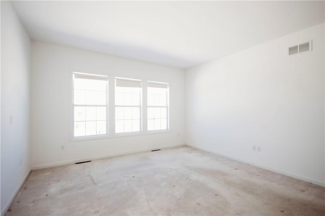 empty room featuring light colored carpet