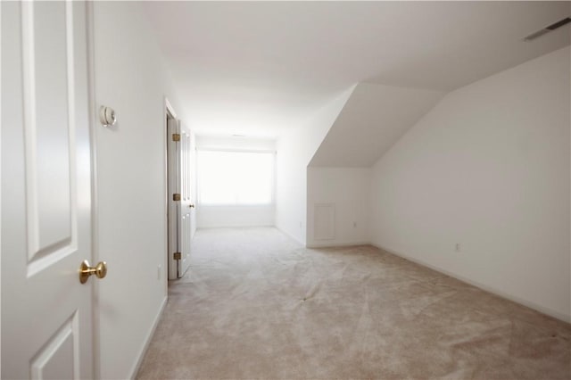 bonus room featuring light carpet and vaulted ceiling