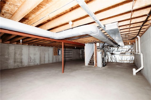 basement featuring water heater and electric panel