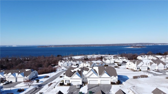 snowy aerial view with a water view