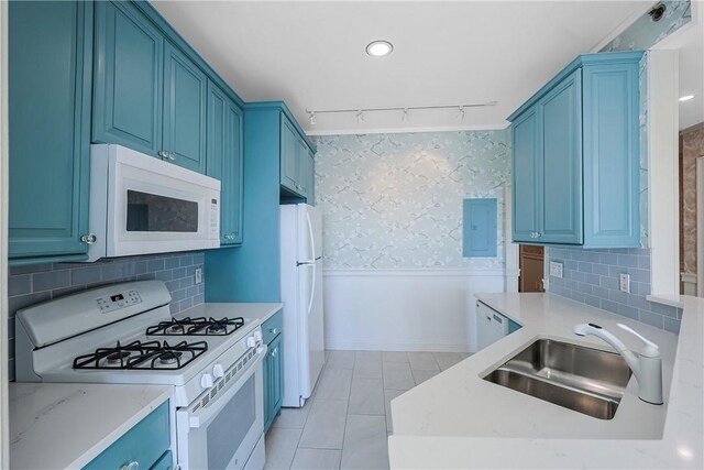 kitchen featuring sink, white appliances, blue cabinetry, and rail lighting