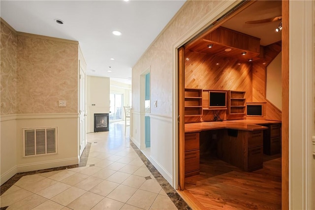 hallway featuring visible vents, a wainscoted wall, recessed lighting, wallpapered walls, and baseboards