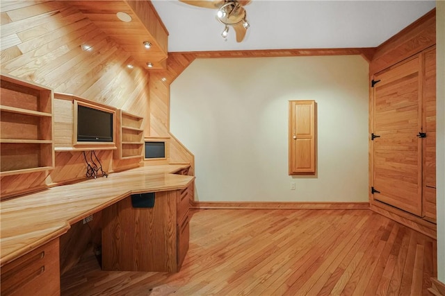 kitchen with open shelves, built in desk, light wood-style floors, baseboards, and ceiling fan