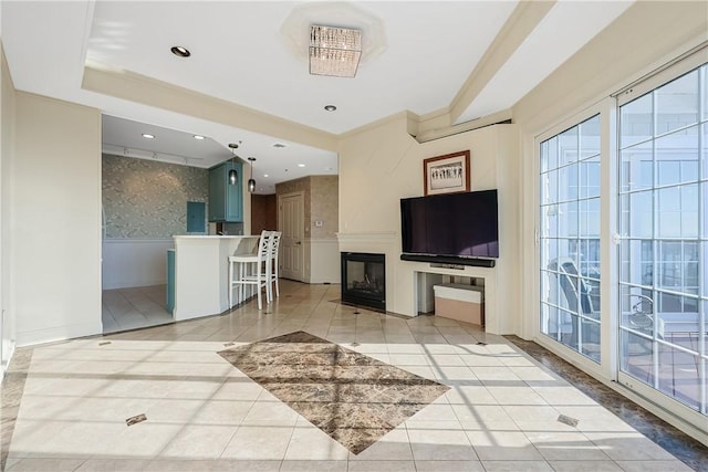 living room with a glass covered fireplace, light tile patterned floors, and recessed lighting