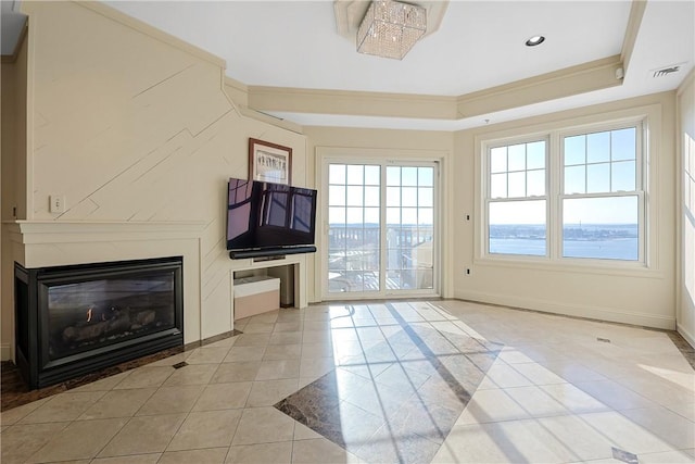 doorway to outside with visible vents, a glass covered fireplace, light tile patterned flooring, crown molding, and baseboards