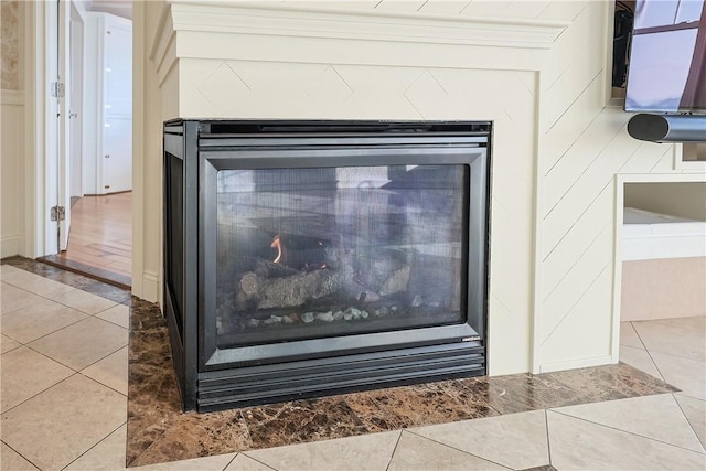 interior details featuring a glass covered fireplace