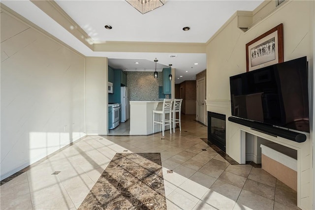 kitchen featuring light tile patterned floors, white appliances, crown molding, and a kitchen breakfast bar