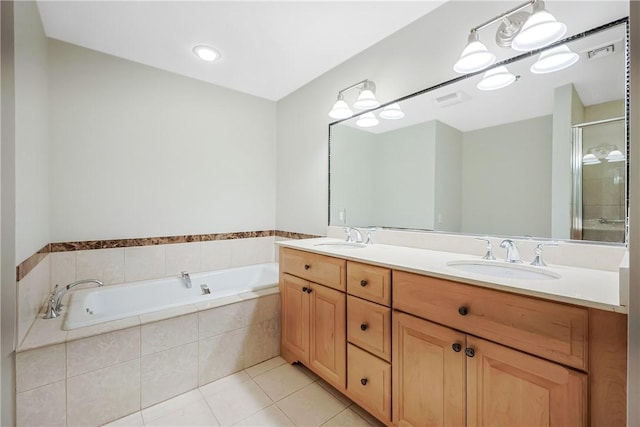 full bath featuring a sink, visible vents, a bath, and tile patterned floors