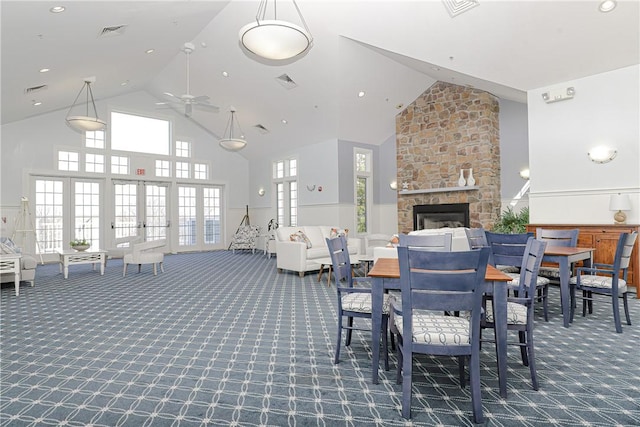 dining space with french doors, visible vents, carpet floors, and high vaulted ceiling