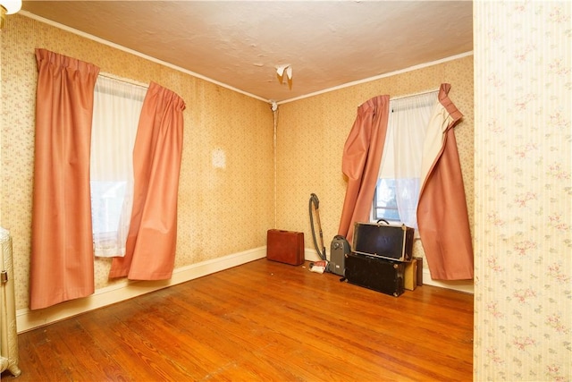 miscellaneous room featuring wood-type flooring and crown molding