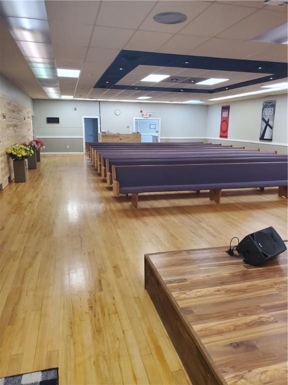 exercise area featuring a drop ceiling and light hardwood / wood-style floors