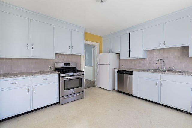 kitchen featuring sink, decorative backsplash, white cabinets, and appliances with stainless steel finishes