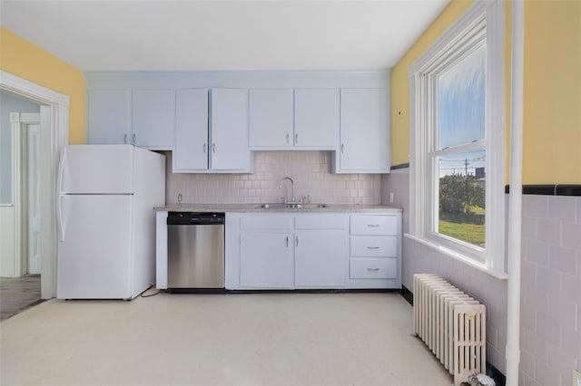 kitchen featuring sink, white cabinetry, stainless steel dishwasher, radiator, and white fridge