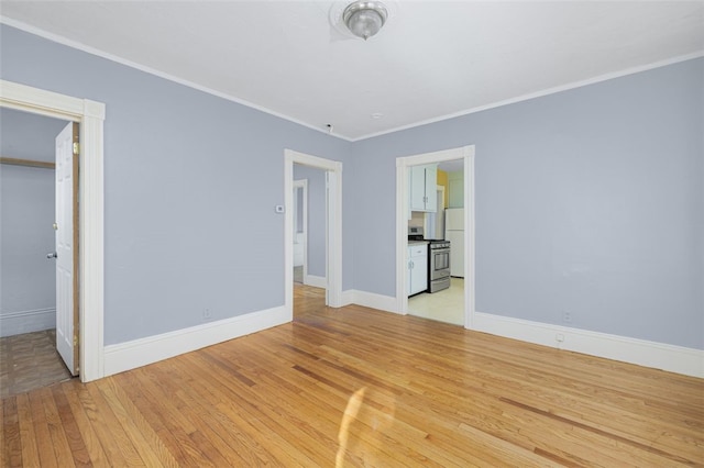 unfurnished bedroom featuring crown molding and light hardwood / wood-style floors