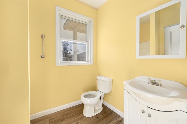 bathroom with vanity, wood-type flooring, and toilet