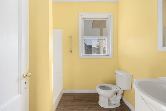 bathroom featuring sink, hardwood / wood-style floors, and toilet