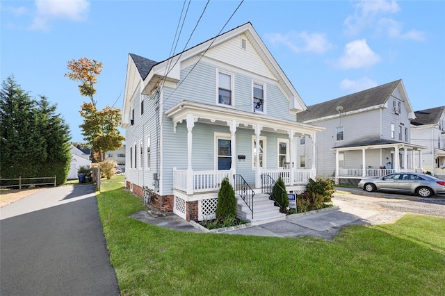 view of front of house with a front yard and covered porch