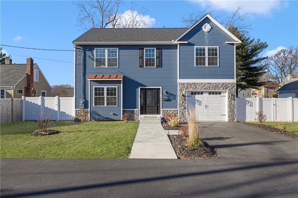 view of front of home with a garage and a front yard