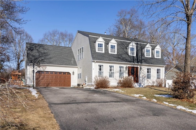 cape cod home featuring a garage