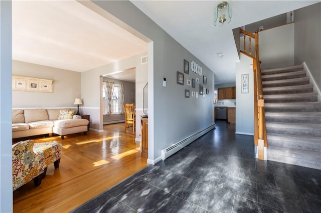 living room featuring dark hardwood / wood-style floors and a baseboard heating unit