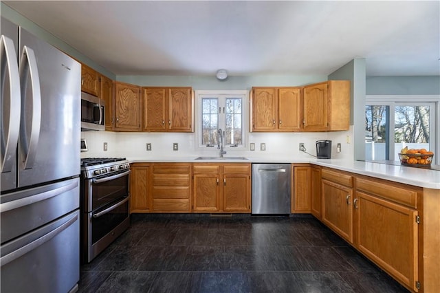 kitchen featuring appliances with stainless steel finishes, sink, kitchen peninsula, and decorative backsplash