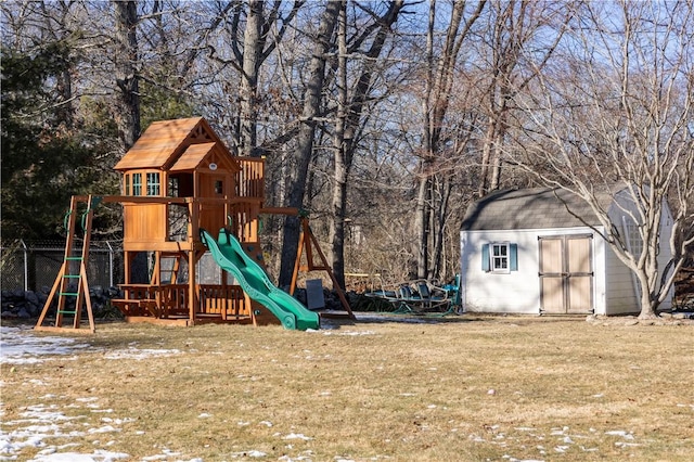 view of playground with a yard and a shed