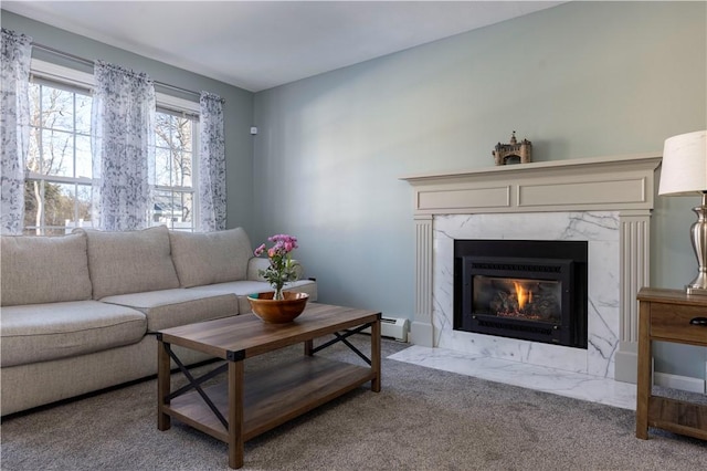 carpeted living room with a high end fireplace and baseboard heating