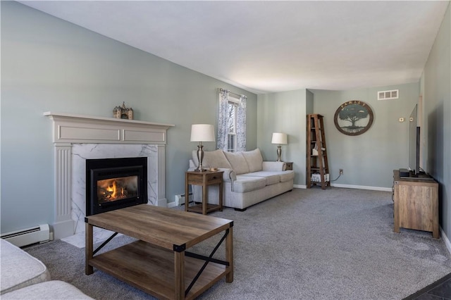 living room featuring dark colored carpet, a premium fireplace, and baseboard heating