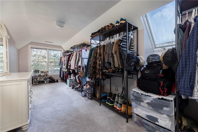 walk in closet featuring lofted ceiling and light carpet