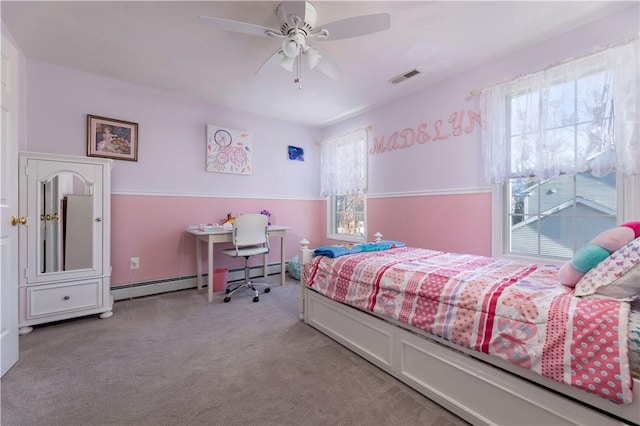 bedroom featuring multiple windows, a baseboard heating unit, light colored carpet, and ceiling fan