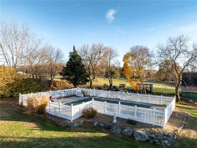 view of pool featuring a lawn