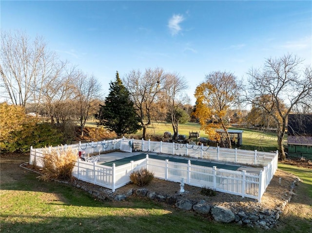 view of swimming pool with a fenced in pool, a yard, and fence