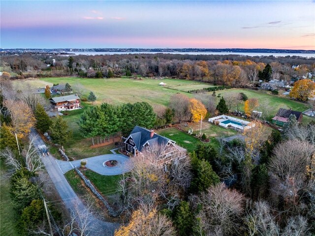 aerial view at dusk with a water view