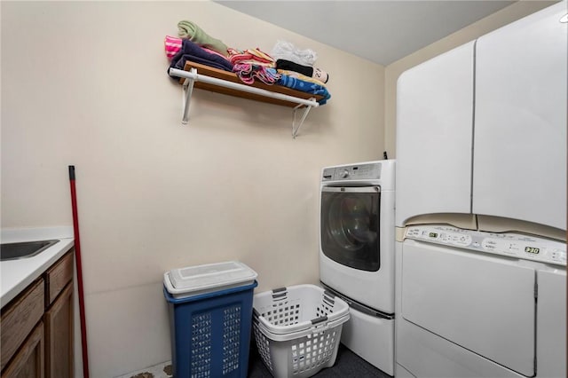 clothes washing area featuring cabinets and washer and dryer