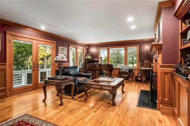 living room featuring visible vents, crown molding, french doors, light wood-type flooring, and recessed lighting