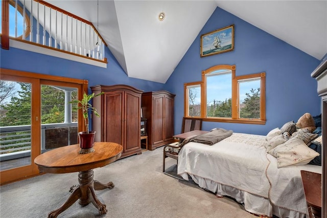 bedroom featuring light carpet, access to outside, and high vaulted ceiling