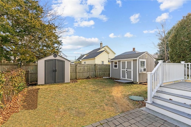 view of yard with a wooden deck, cooling unit, and a storage shed