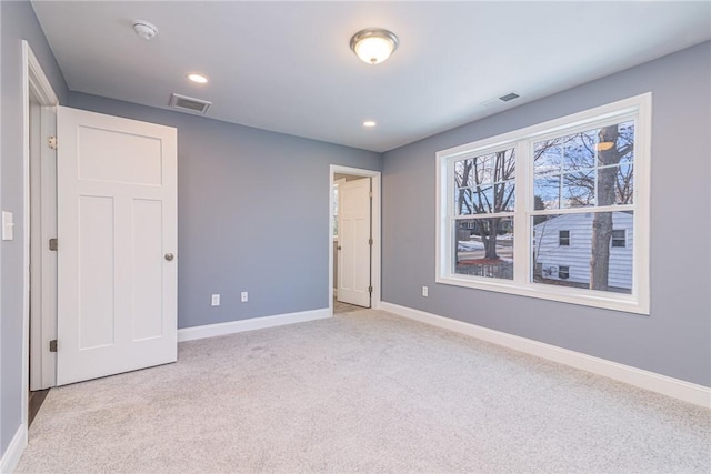 unfurnished bedroom with light colored carpet