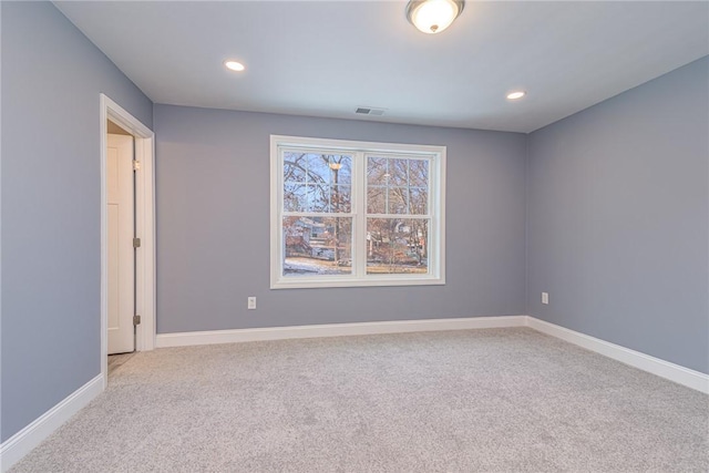 empty room featuring light carpet