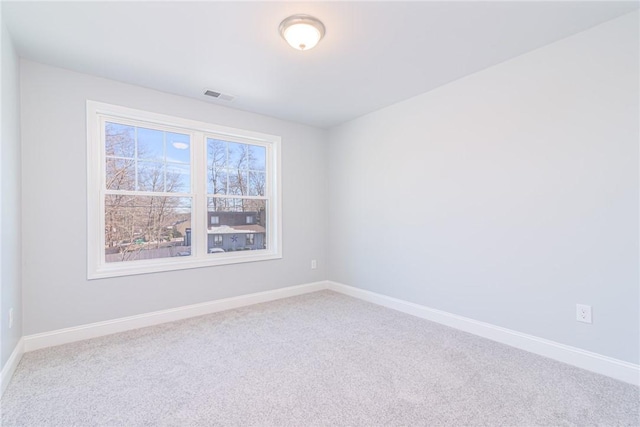 spare room featuring plenty of natural light and carpet