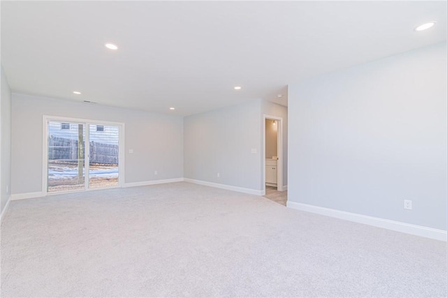 unfurnished room featuring light carpet