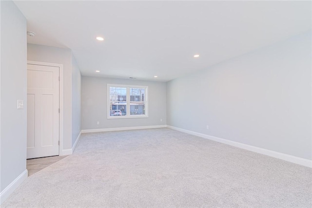 unfurnished room featuring light carpet