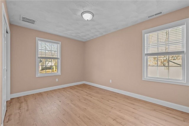 unfurnished room with light hardwood / wood-style flooring