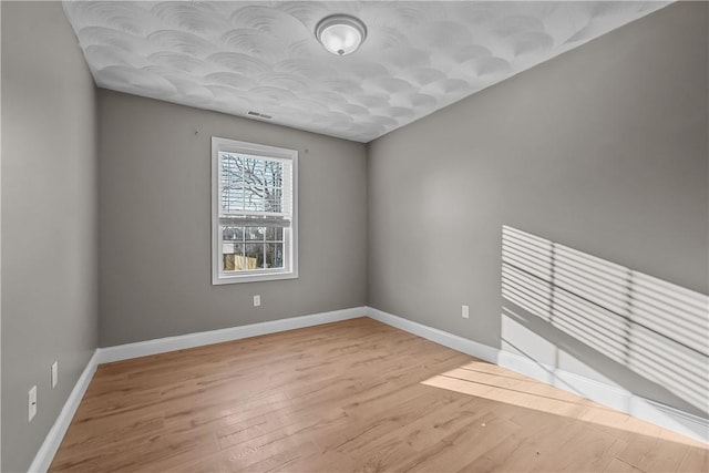 spare room featuring light wood-type flooring