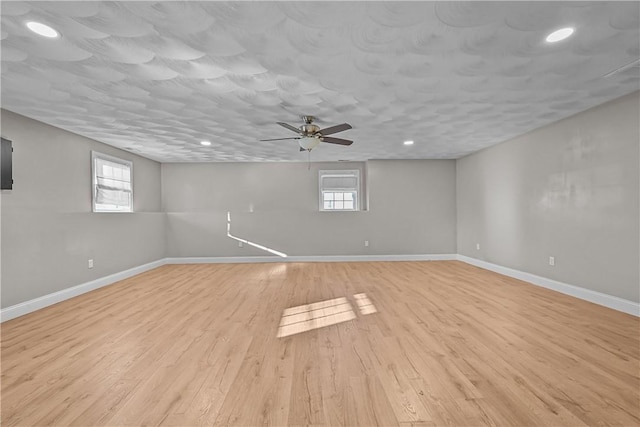 spare room featuring light hardwood / wood-style floors and ceiling fan